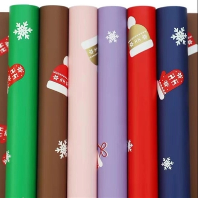 Un bon prix. Papier d'emballage 58cm x 58cm de fleur de cadeau de Noël 20 feuilles dans le sac en ligne