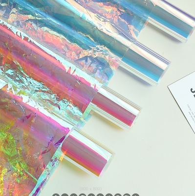 Un bon prix. Papier d'emballage de fleurs en film de couleur, papier perlé, arc-en-ciel laser, papier transparent à sept couleurs de bonbons, matériau d'emballage de fleurs de couleur en ligne